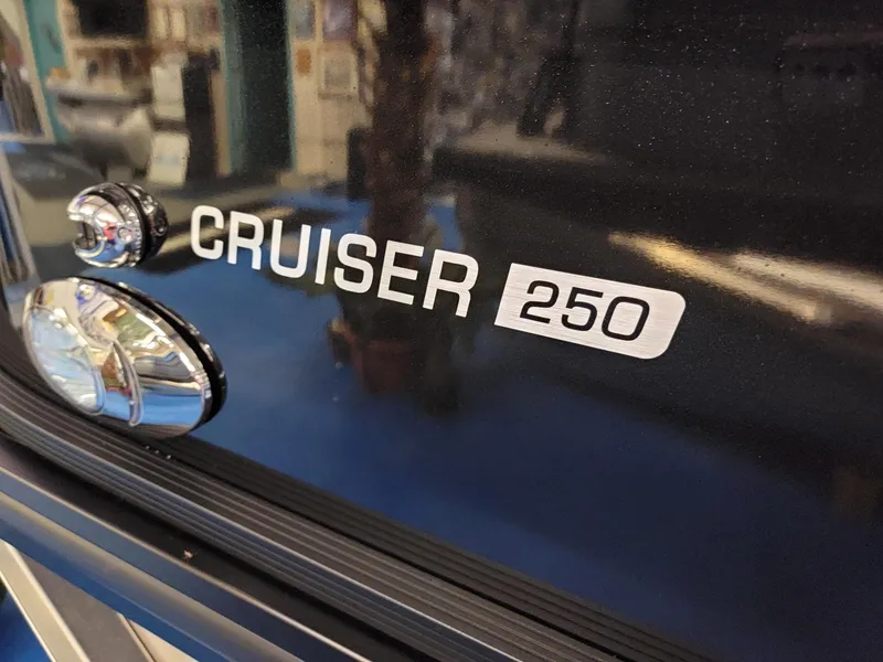 Slide: The Image of Close-up of 2024 Harris Cruiser 250 boat model nameplate. - 28