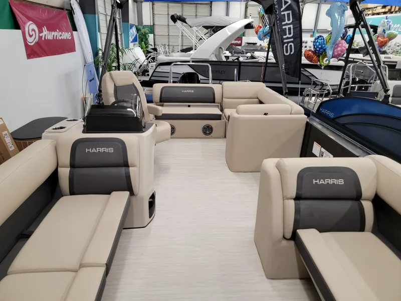 Slide: The Image of 2024 Harris Cruiser 250 pontoon boat interior with beige and gray seating. - 4