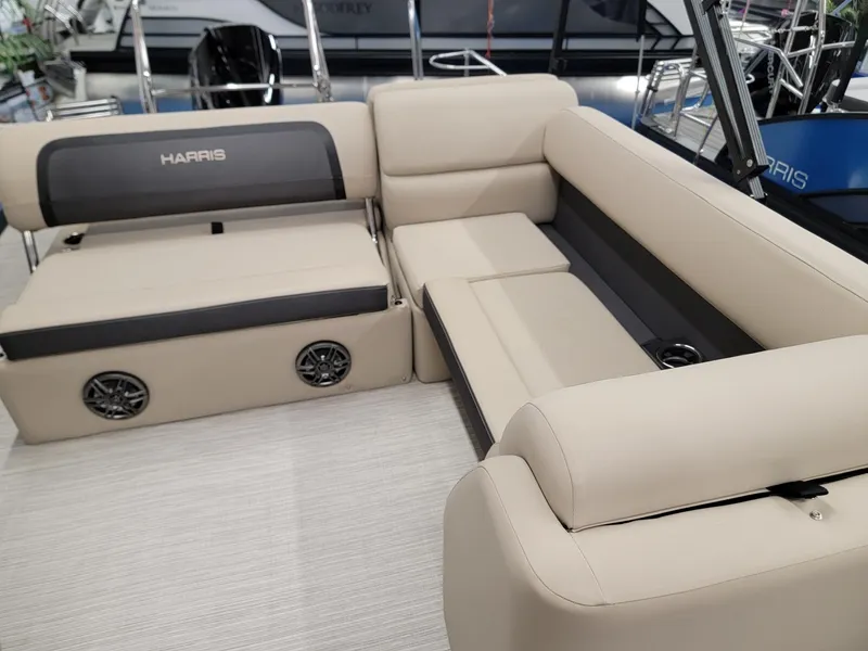 Slide: The Image of 2024 Harris Cruiser 250 boat interior with beige seating and built-in speakers. - 7