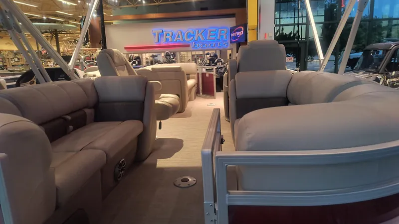 Slide: The Image of 2024 Sun Tracker Party Barge 22 DLX pontoon boat interior at Tracker Boats showroom. - 2