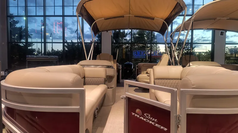 Slide: The Image of 2024 Sun Tracker Party Barge 22 DLX pontoon boat with beige seating and canopy. - 3