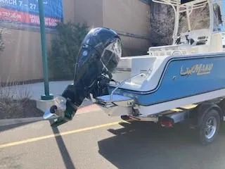 Slide: The Image of 2024 Mako 214 CC boat on trailer with outboard motor. - 2