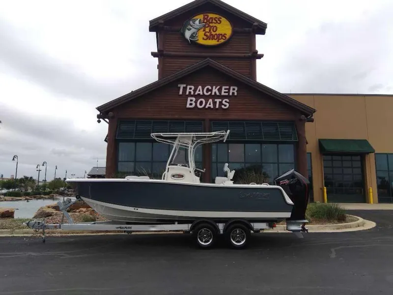 Slide: The Image of 2024 Mako 214 CC boat on trailer outside Bass Pro Shops Tracker Boats. - 0