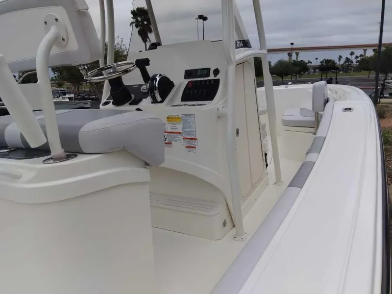 Slide: The Image of 2024 Mako 214 CC boat interior with helm and seating. - 4