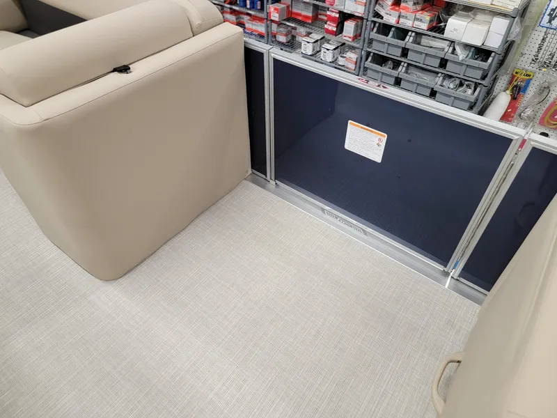 Slide: The Image of 2024 Harris Cruiser 210 interior seating and storage area. - 10
