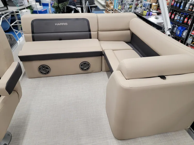 Slide: The Image of 2024 Harris Cruiser 210 boat interior with beige seating and built-in speakers. - 11