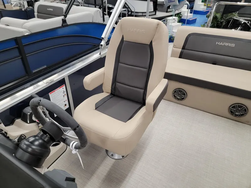 Slide: The Image of 2024 Harris Cruiser 210 boat interior with captain's chair and steering wheel. - 12