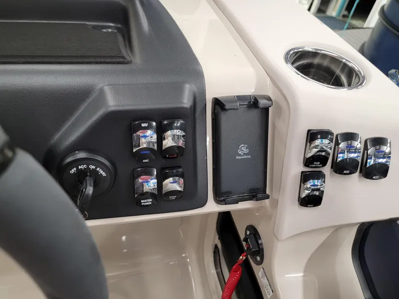 Slide: The Image of Control panel of 2024 Harris Cruiser 210 boat with switches and cup holder. - 16