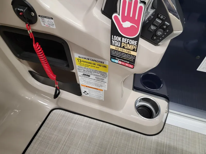 Slide: The Image of Control panel of 2024 Harris Cruiser 210 boat with safety and capacity labels. - 17