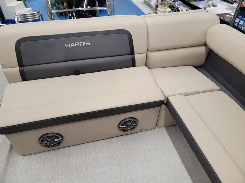 Slide: The Image of 2024 Harris Cruiser 210 boat interior with beige seating and built-in speakers. - 18