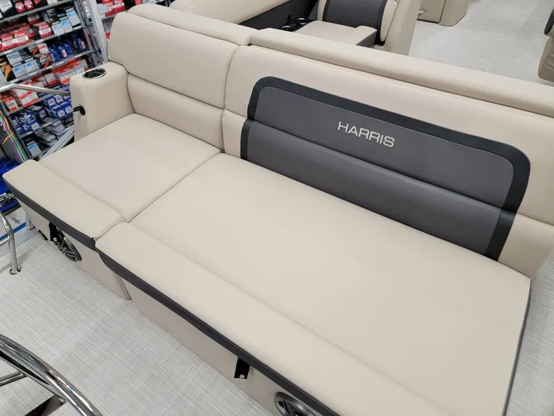 Slide: The Image of 2024 Harris Cruiser 210 boat interior seating with beige and gray upholstery. - 22
