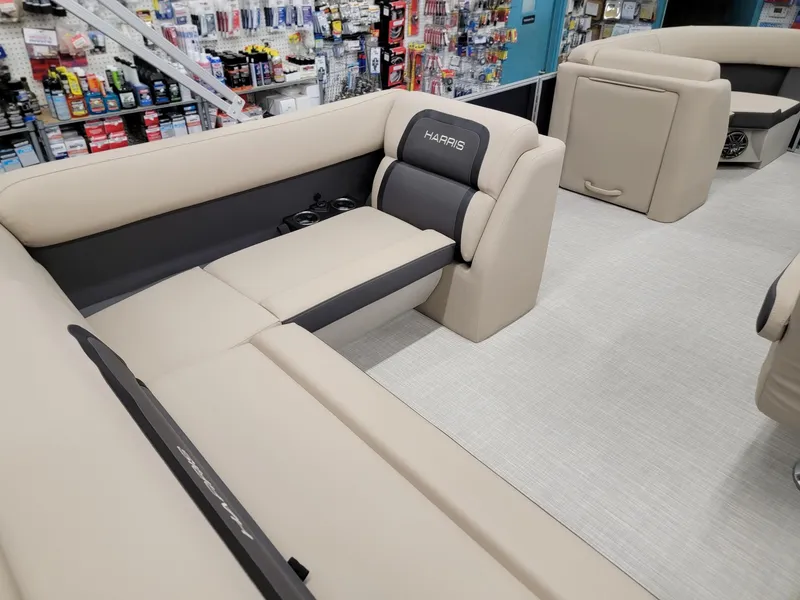 Slide: The Image of 2024 Harris Cruiser 210 boat interior with beige and gray seating. - 24