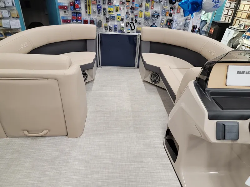 Slide: The Image of 2024 Harris Cruiser 210 boat interior with beige seating and modern dashboard. - 26