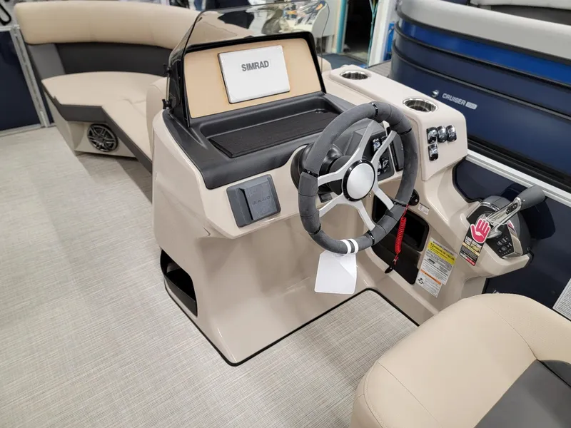 Slide: The Image of 2024 Harris Cruiser 210 boat interior with steering console and seating. - 27