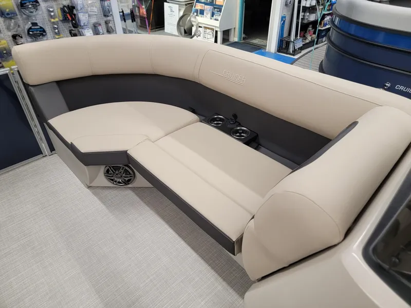 Slide: The Image of 2024 Harris Cruiser 210 boat interior with beige seating and cup holders. - 29