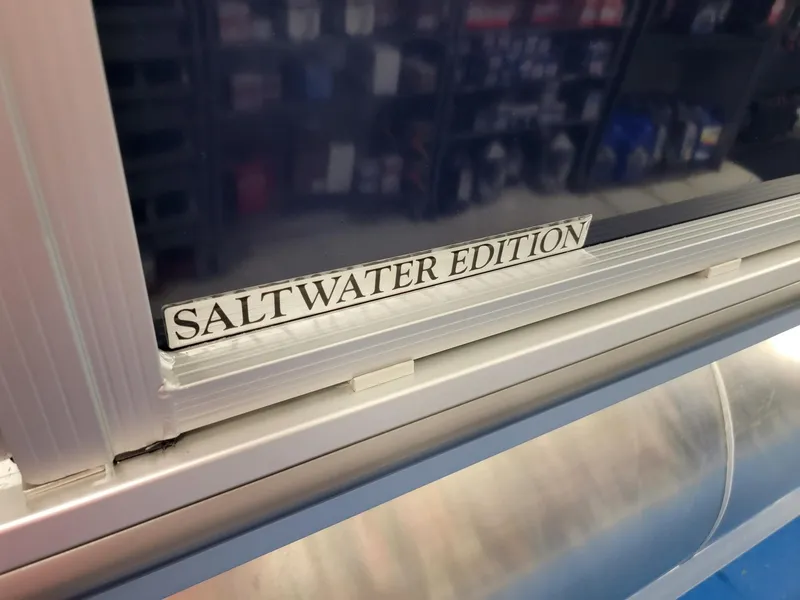 Slide: The Image of 2024 Harris Cruiser 210 Saltwater Edition label on boat window. - 31