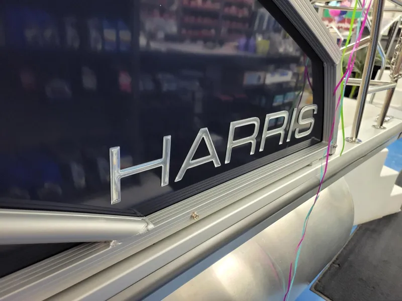 Slide: The Image of 2024 Harris Cruiser 210 boat close-up with logo. - 32