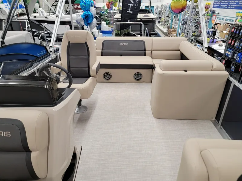 Slide: The Image of 2024 Harris Cruiser 210 pontoon boat interior with beige seating and modern design. - 7