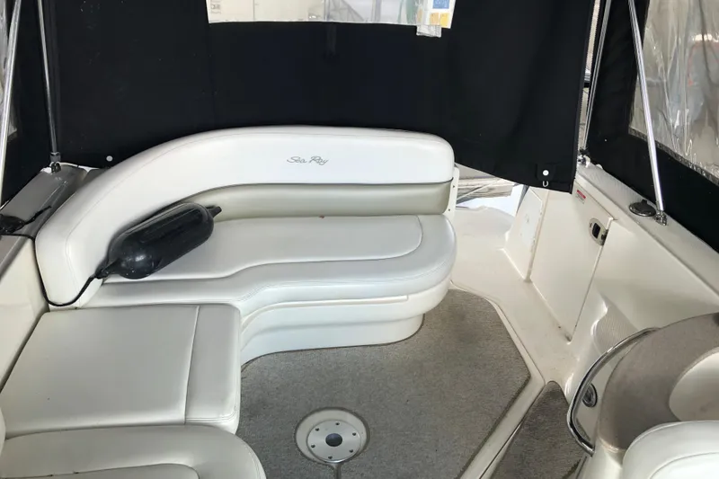 Slide: The Image of Interior of 2007 Sea Ray 260 Sundancer with white leather seating and black curtains. - 17