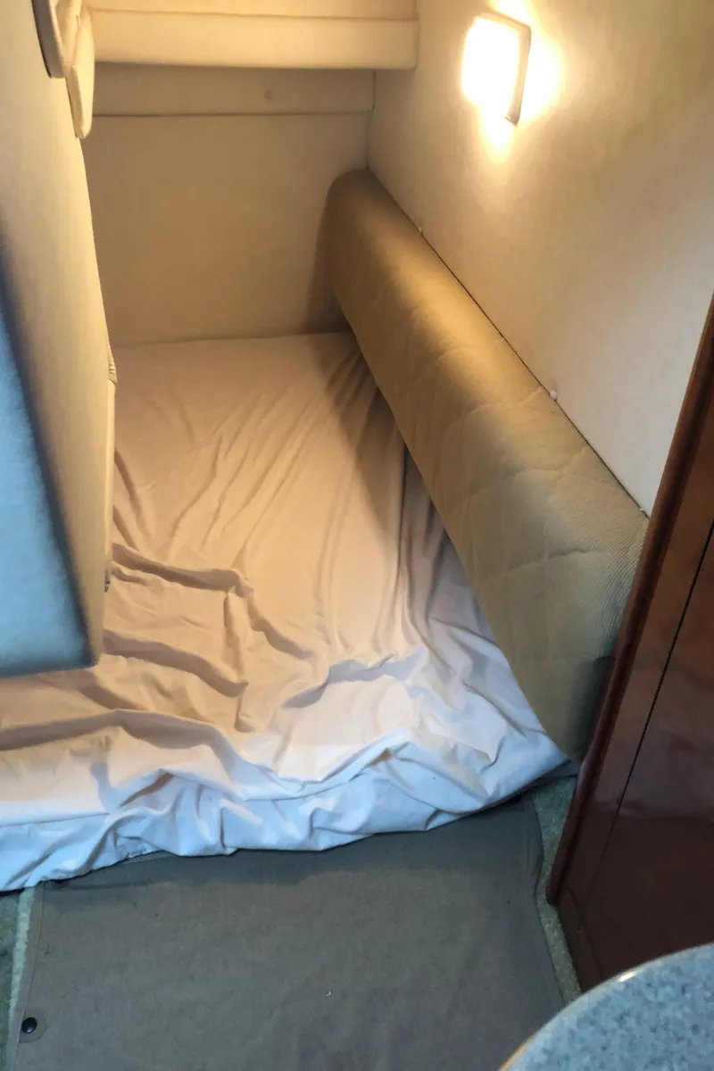 Slide: The Image of Interior cabin of 2007 Sea Ray 260 Sundancer with bed and wall light. - 25