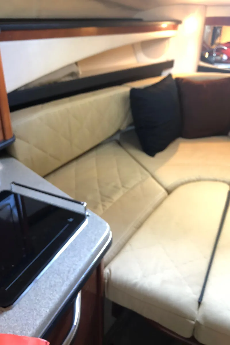 Slide: The Image of 2007 Sea Ray 260 Sundancer cabin interior with beige seating and black pillows. - 34