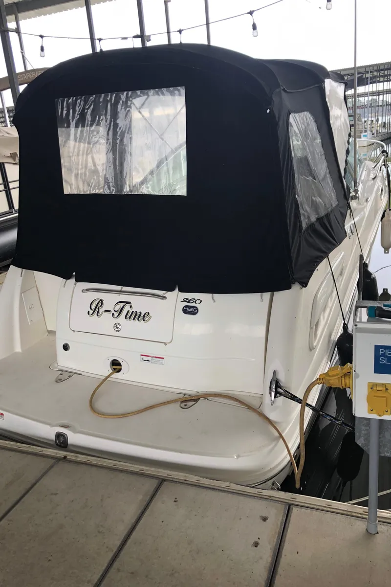 Slide: The Image of 2007 Sea Ray 260 Sundancer docked with black canvas cover. - 4