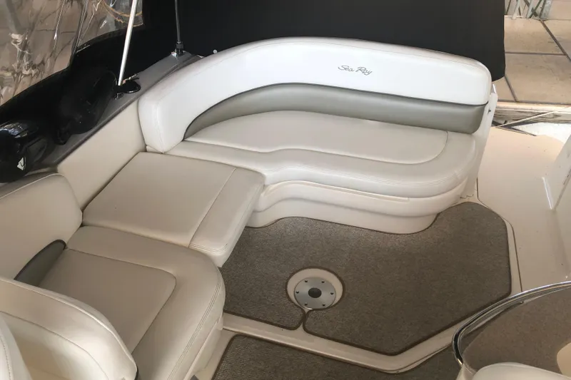 Slide: The Image of 2007 Sea Ray 260 Sundancer interior seating area with white and gray upholstery. - 41