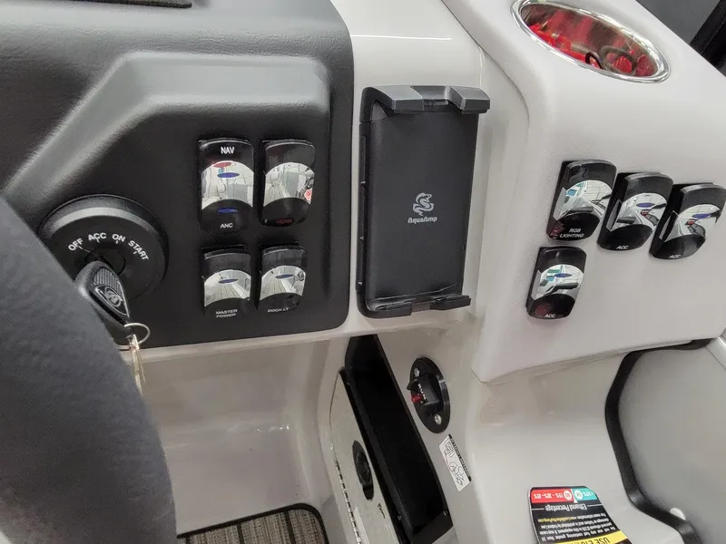 Slide: The Image of Control panel of 2024 Harris Sunliner 210 boat with switches and phone holder. - 12