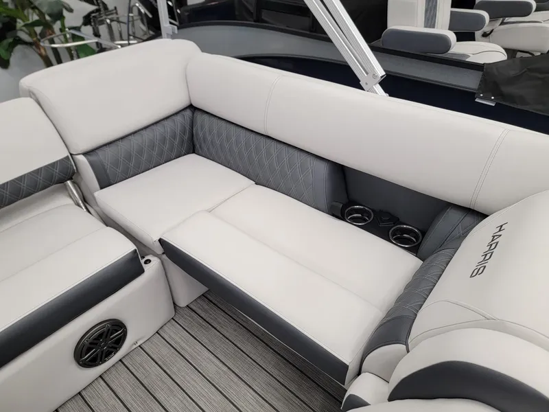 Slide: The Image of 2024 Harris Sunliner 210 boat interior with plush seating and cup holders. - 15