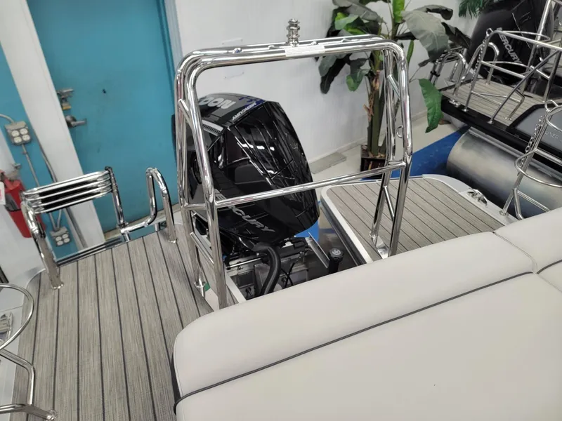 Slide: The Image of 2024 Harris Sunliner 210 boat interior with motor and seating. - 17