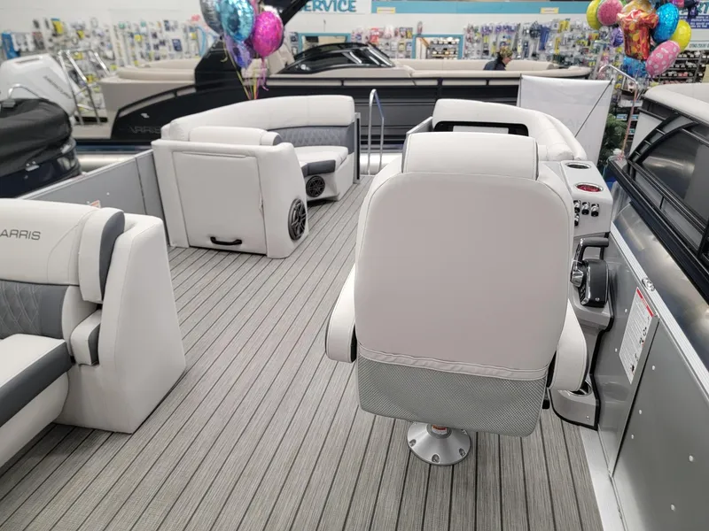 Slide: The Image of 2024 Harris Sunliner 210 boat interior with plush seating and modern design. - 21