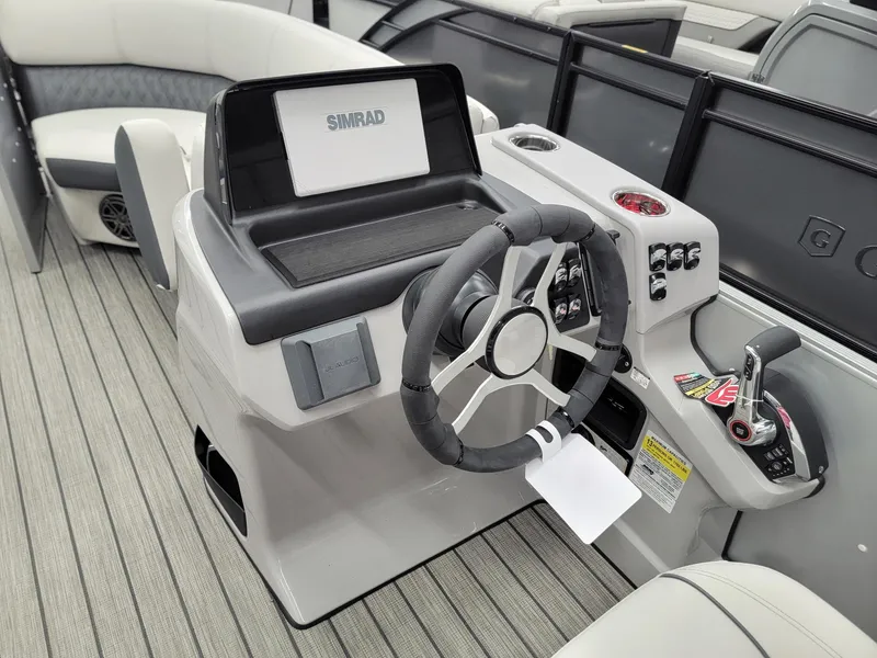 Slide: The Image of 2024 Harris Sunliner 210 boat helm with steering wheel and control panel. - 23