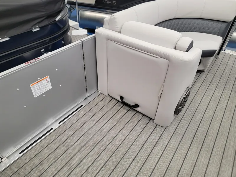 Slide: The Image of 2024 Harris Sunliner 210 boat interior with gray seating and flooring. - 24