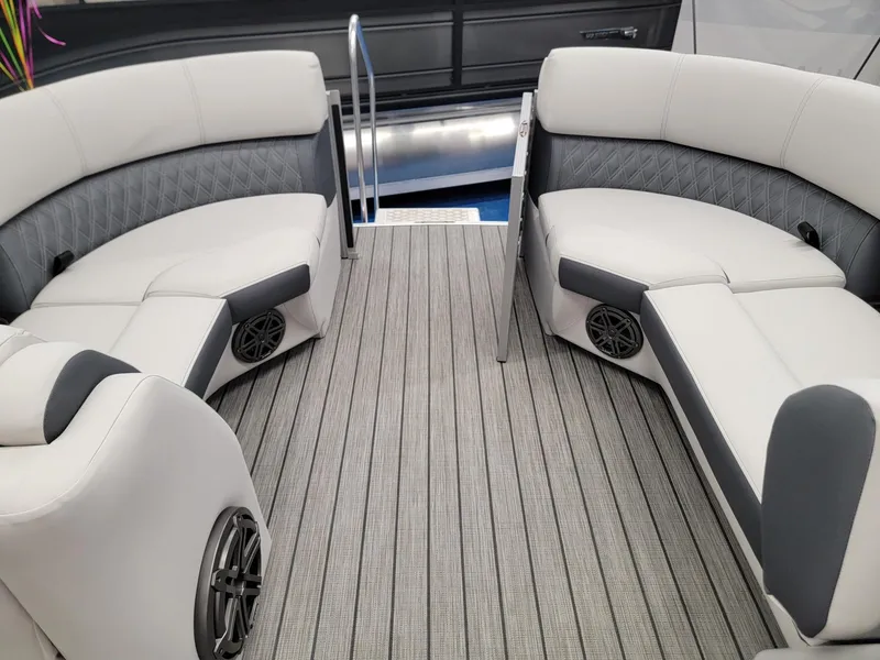 Slide: The Image of 2024 Harris Sunliner 210 boat interior with plush seating and marine speakers. - 25
