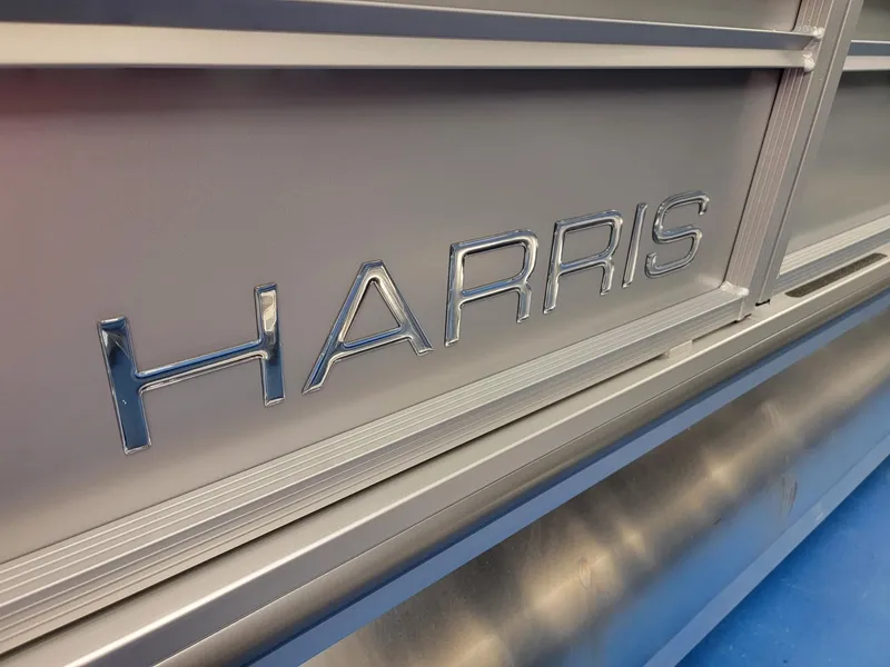 Slide: The Image of Close-up of 2024 Harris Sunliner 210 boat with metallic Harris logo. - 28