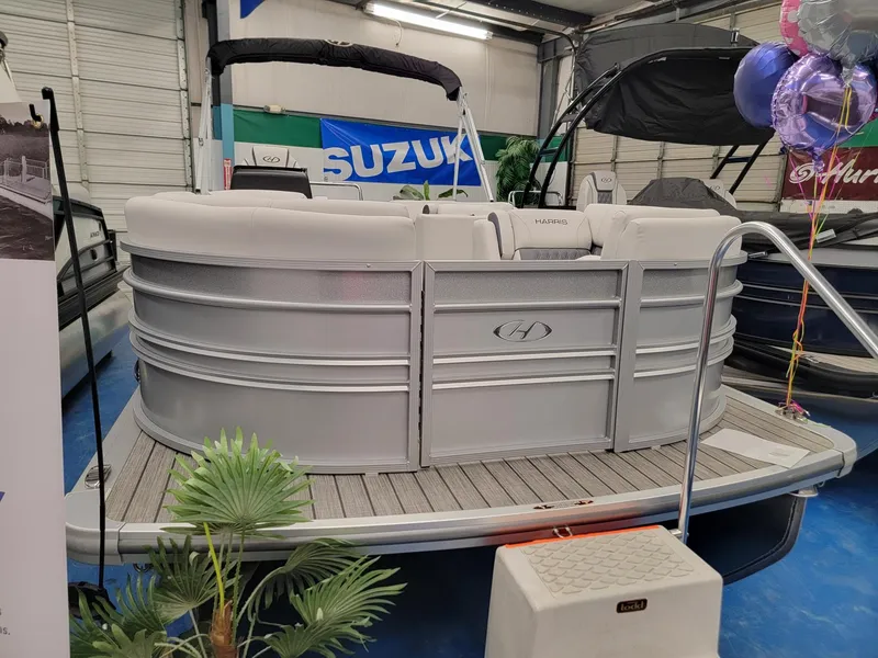 Slide: The Image of 2024 Harris Sunliner 210 pontoon boat on display in showroom. - 3