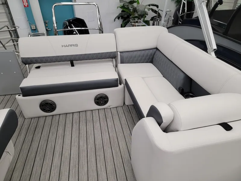 Slide: The Image of 2024 Harris Sunliner 210 boat interior with plush seating and built-in speakers. - 7