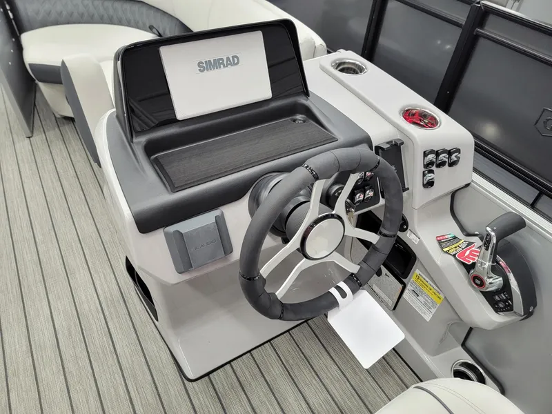 Slide: The Image of 2024 Harris Sunliner 210 boat helm with Simrad display and modern controls. - 9