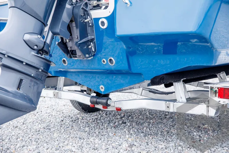 Slide: The Image of 2024 Tidewater 1910 Bay Max boat on a trailer, close-up of the motor and hull. - 11