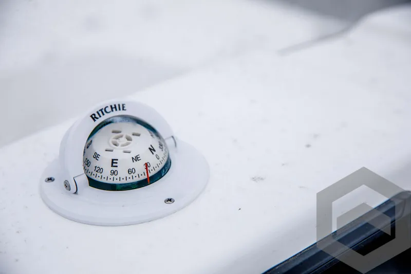 Slide: The Image of Close-up of a Ritchie compass on a 2024 Tidewater 1910 Bay Max boat. - 31