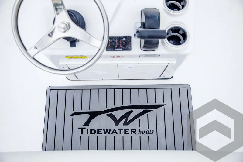 Slide: The Image of 2024 Tidewater 1910 Bay Max boat console with steering wheel and branded mat. - 32