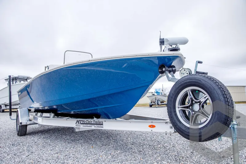Slide: The Image of 2024 Tidewater 1910 Bay Max boat on trailer, blue hull, side view. - 8