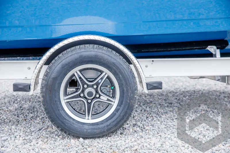 Slide: The Image of Close-up of 2024 Tidewater 1910 Bay Max trailer wheel on gravel. - 9