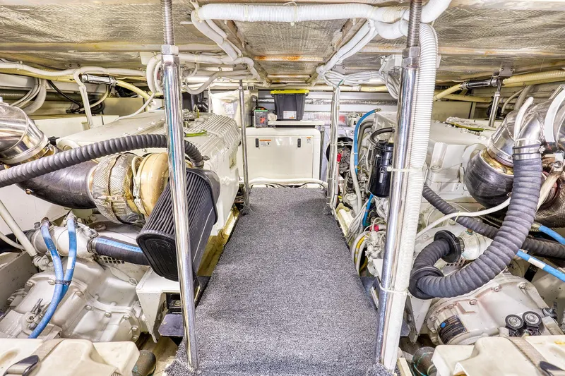 Slide: The Image of Engine room of 2005 Carver 560 Voyager yacht, showcasing mechanical components and systems. - 14