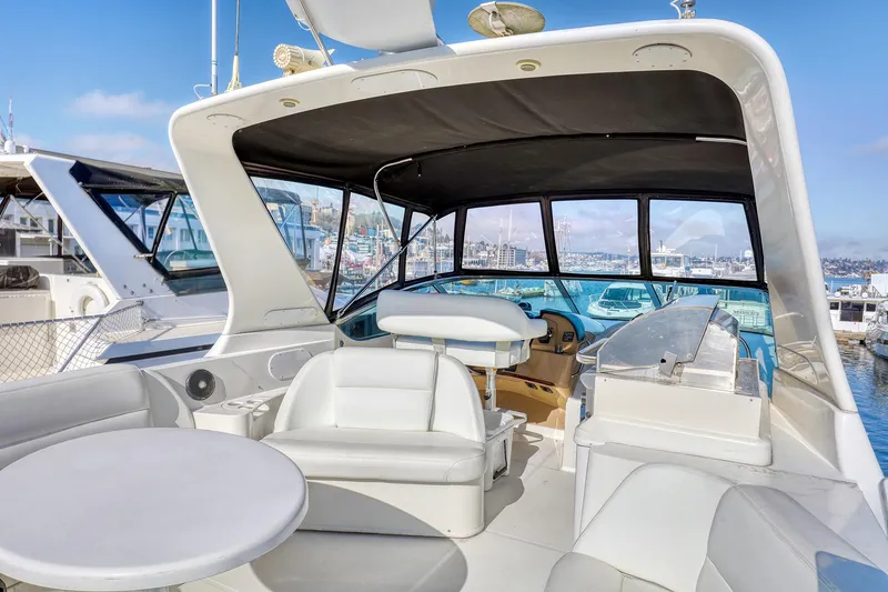 Slide: The Image of 2005 Carver 560 Voyager yacht interior with seating and helm, docked at marina. - 3