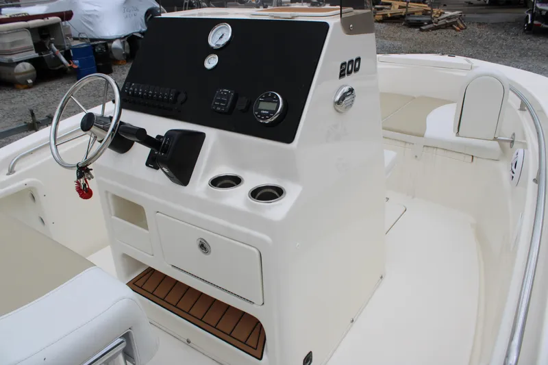 Slide: The Image of 2024 Bulls Bay 200 Center Console boat interior with steering wheel and control panel. - 13