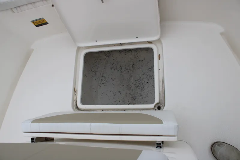 Slide: The Image of 2024 Bulls Bay 200 Center Console storage compartment with open hatch. - 15