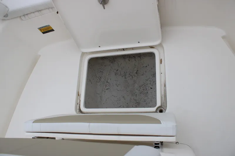 Slide: The Image of 2024 Bulls Bay 200 Center Console storage compartment with cushioned seating. - 16