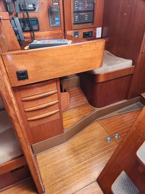 Slide: The Image of Interior of a 1984 Nautor Swan 391 sailboat with wooden cabinetry and navigation station. - 12