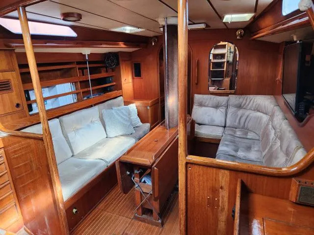 Slide: The Image of Interior of 1984 Nautor Swan 391 sailboat with wooden furnishings and cozy seating. - 2